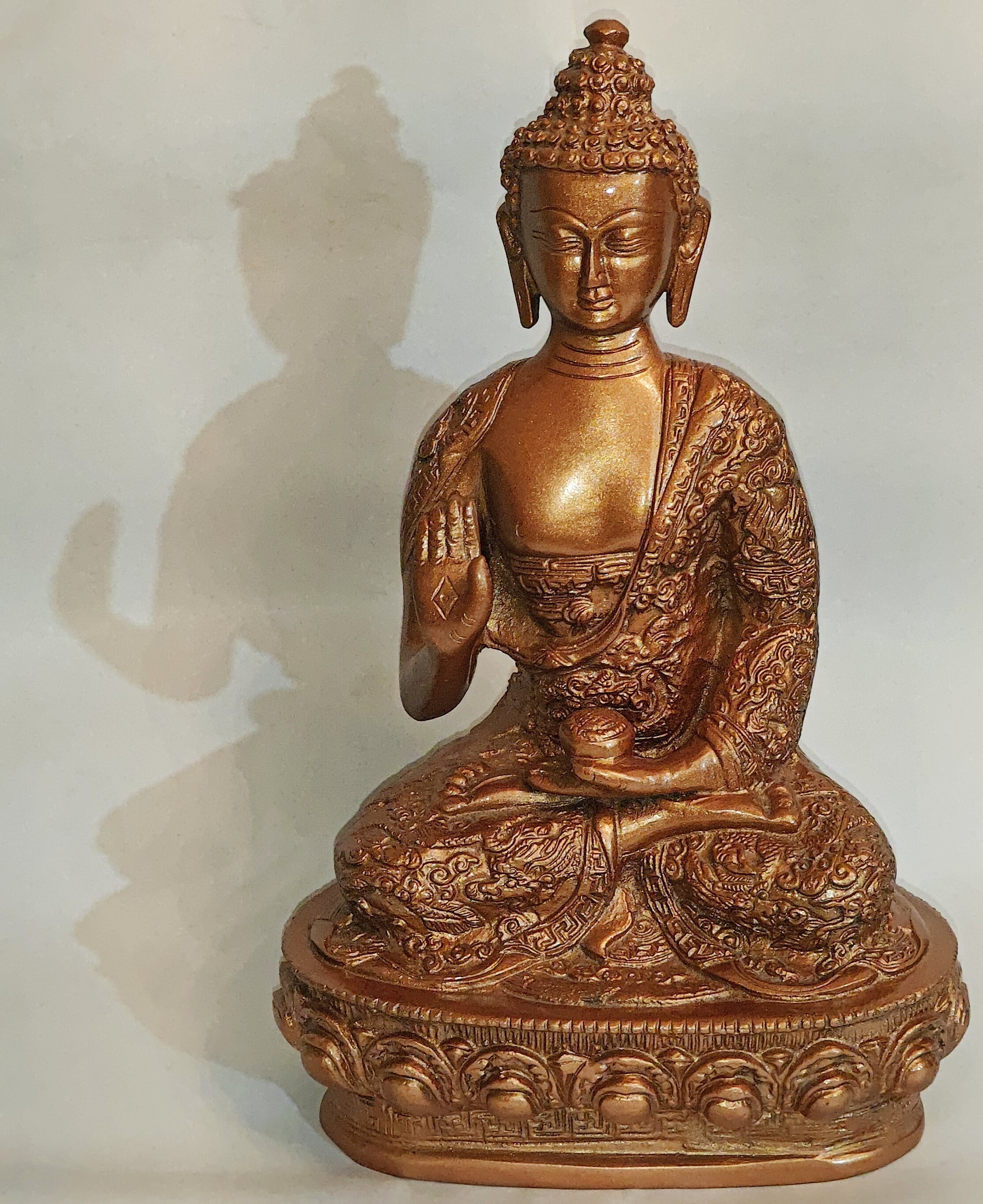 Brass Lord Buddha idol, seated with robe details and raised right hand