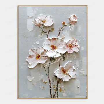 Blush pink and white textured floral wall art with gold flower centers and brown stems on a pale blue-gray background